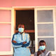 Tuberculosis patients, wearing masks to stop the spread of the disease, stand outside their ward at Chiulo Hospital, Cunene province